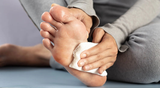 What causes sweating in the feet?